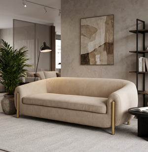 Beige sofa with brass legs styled in showroom